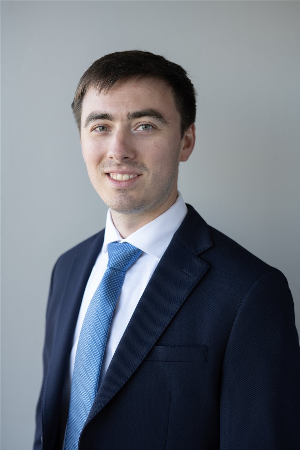 Jack Leick in a navy suit and blue tie